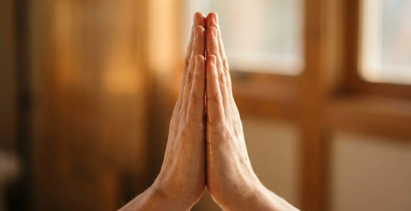 Mains jointes réchauffant de l'huile de massage entre les paumes dans une lumière dorée